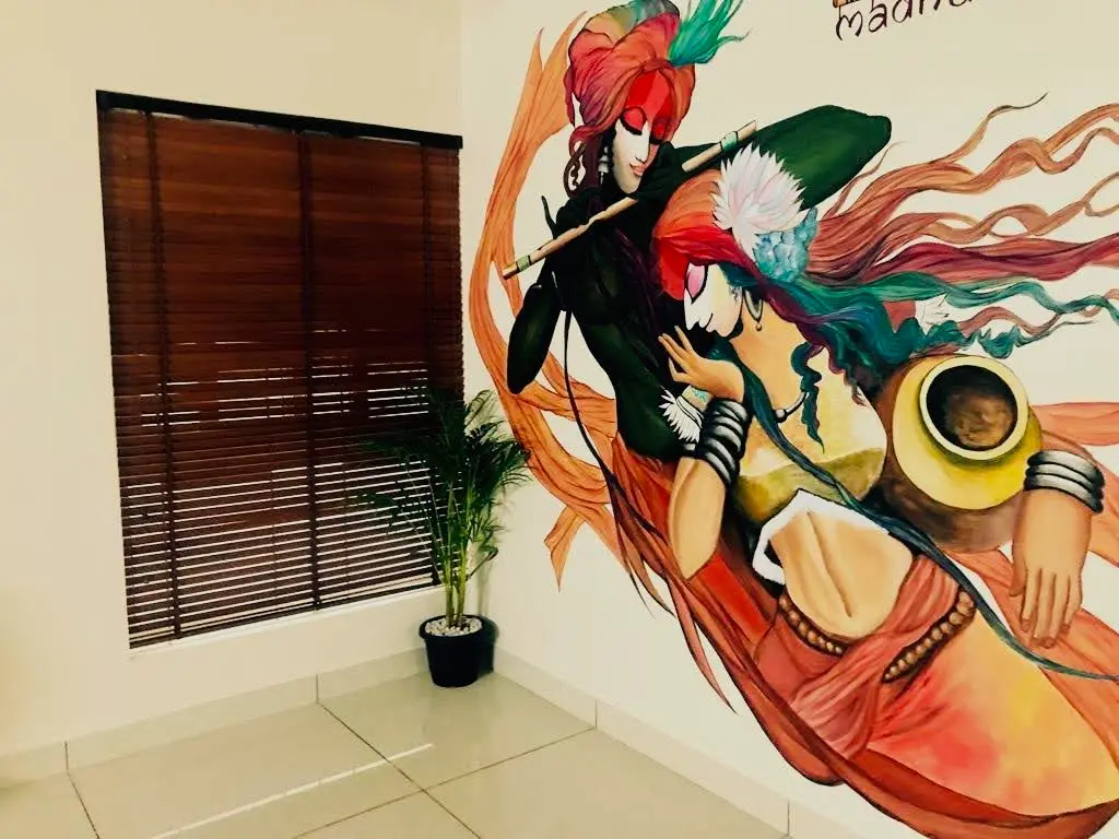 Radha Krishna mural in a Bangalore living room, 10x10 ft hand-painted wall art by mounik.art in a flowing contemporary Indian style